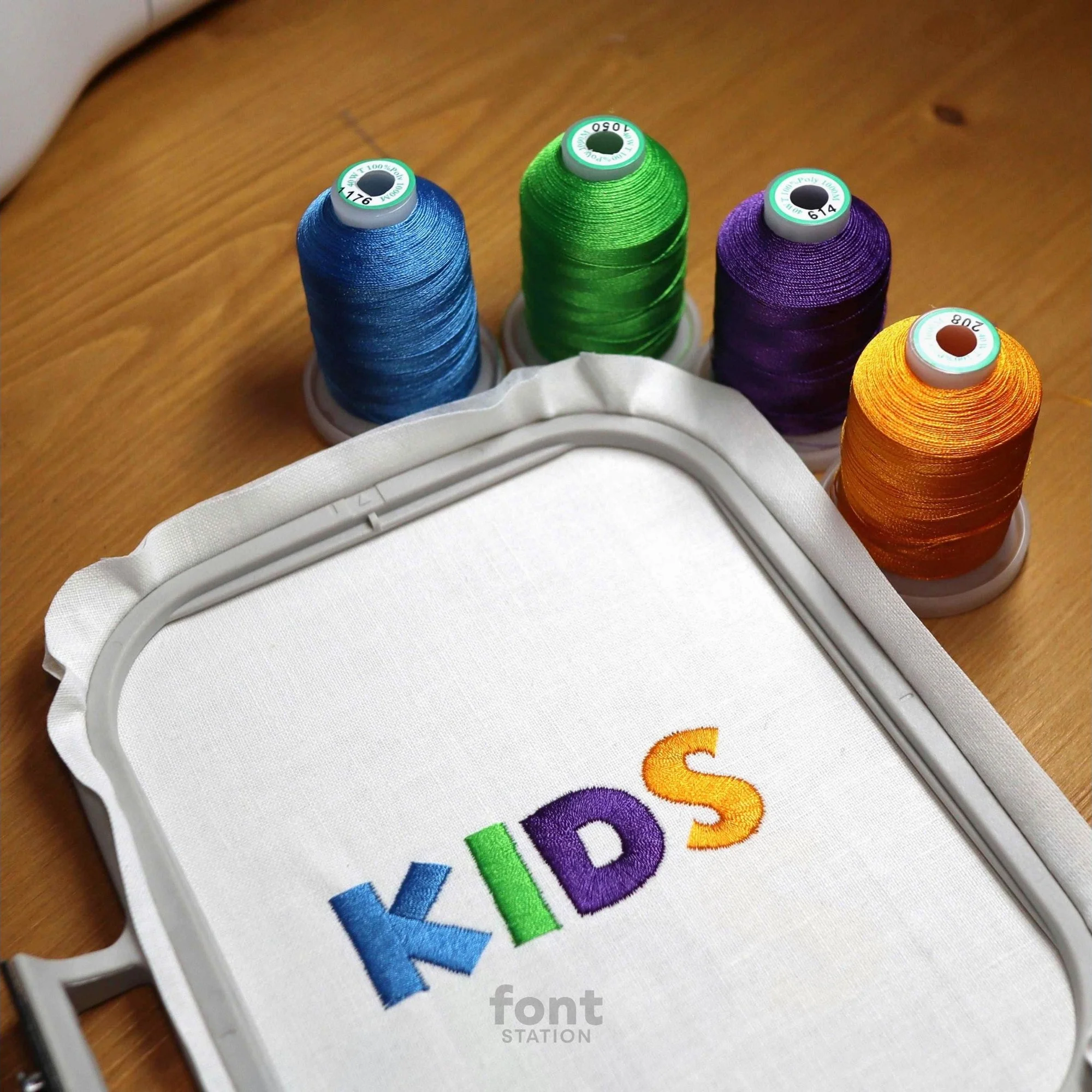 Image showing a word embroidered on textile using the Kids embroidery font created by FontStation